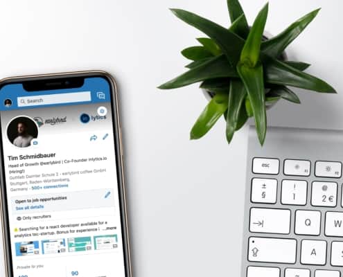LinkedIn on Mobile next to a keyboard and plant