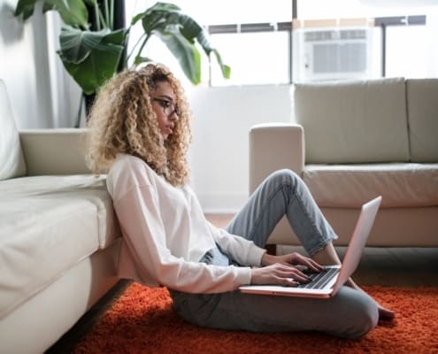 Young woman working from home in her living room
