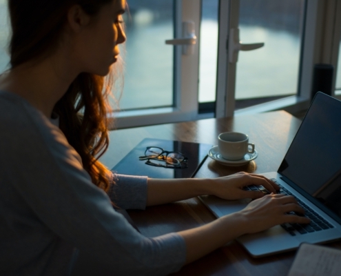 Woman working from home in the dark