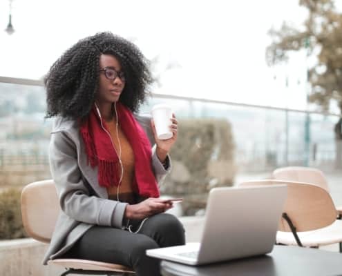 Professional woman drinking coffee while working