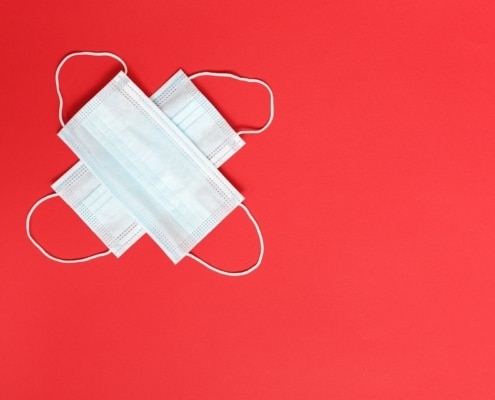 2 masks against a red backdrop