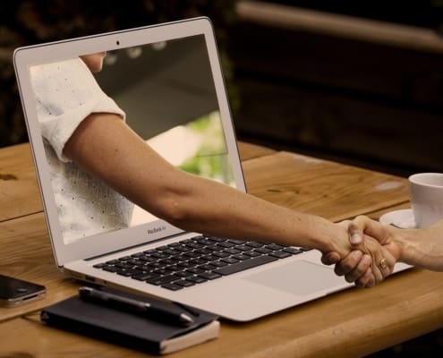 Handshake through a laptop screen