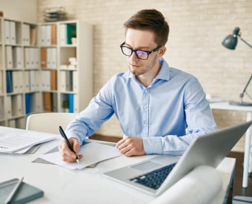 Businessman making notes or writing plans for working day