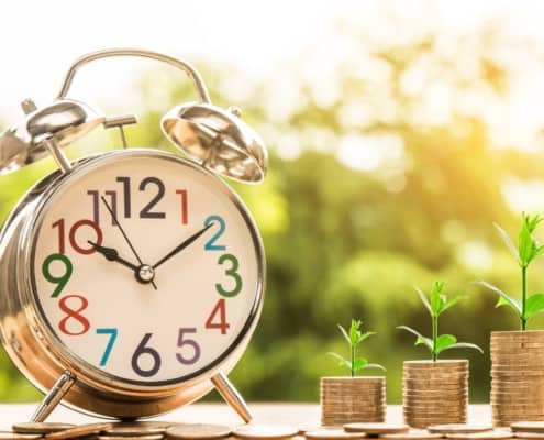 Clock and coin stacks representing penions