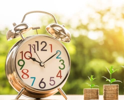 Clock and coin stacks representing penions
