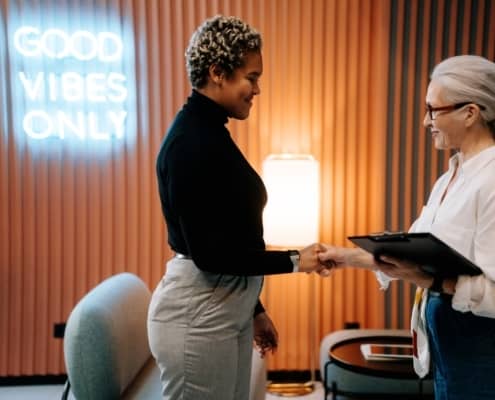 Two women shaking hands after a job interview